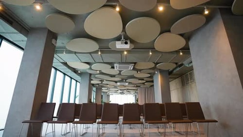 Modern Conference Hall with Empty Chairs and Projector