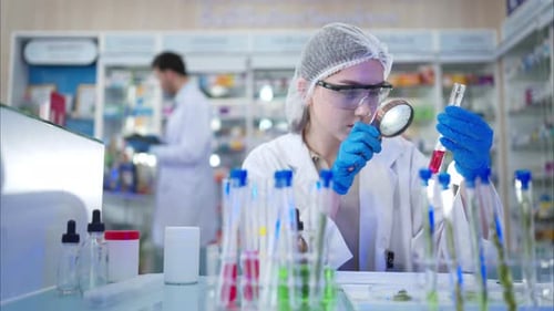 Scientist Examining Red Liquid in Test Tube