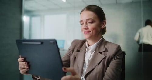 Woman Video Calling on Tablet in Bright Office
