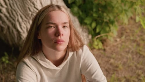 Young Woman Sitting near a Tree