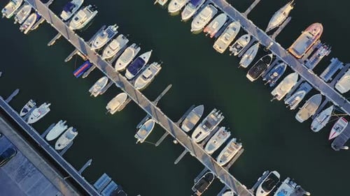 Aerial Overhead View of a Row of Yachts in Marina with Moored Sailboats