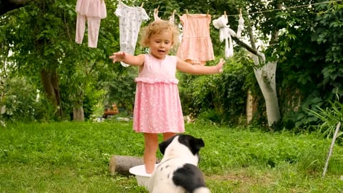 The Child is Washing Clothes in the Garden Selective Focus
