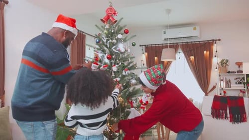 Family Decorating Christmas Tree in Cozy Home