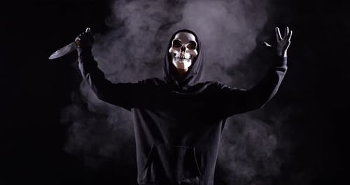 Hooded Figure with Mask Holding Knife