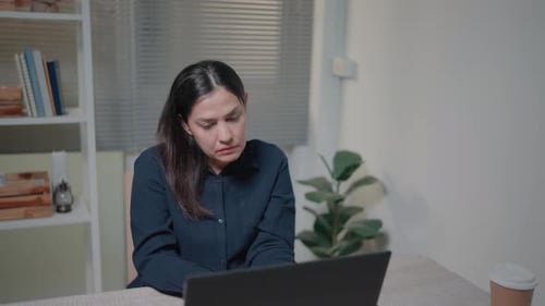 Sad woman having financial problems or cash gap in business, throwing away pay check, sitting at tab