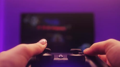 Hands Playing a Video Game with Controller