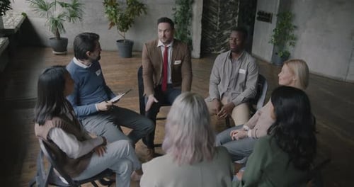 Diverse People Comforting a Man in a Group Session