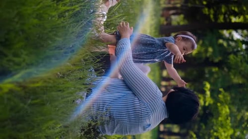 Mother and child together in the park outdoors, lying in the grass. Motherhood happiness concept. Da