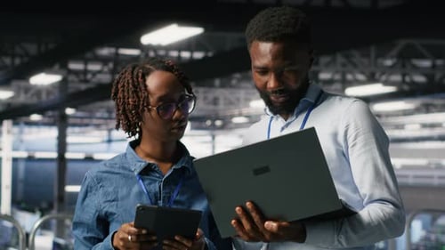 Data Center System Administrators Using Laptop to Review AI LLM Visualizations