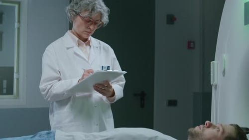 Patient Lying on Scanner Bed, Speaking with Doctor before MRI Procedure