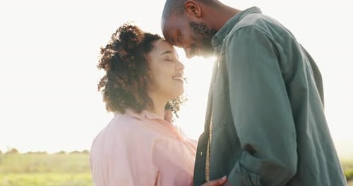 Loving Couple Embraces in Scenic Field at Sunset