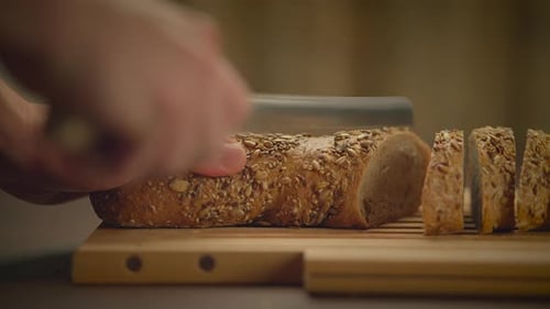 Slicing Fresh Bread on Cutting Board, Close Up