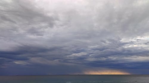 Stormy Sky over Ocean with Golden Light