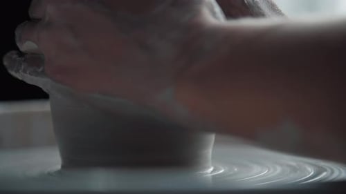 Hands Shaping Clay on a Potter's Wheel