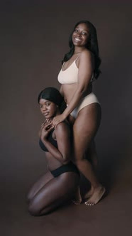 Two Young Stunning Women in Lingerie Posing for Camera in Studio