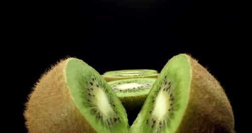 Fresh green kiwi fruit cut in half super close up shoot fly over 4k high quallity shoot on dark back