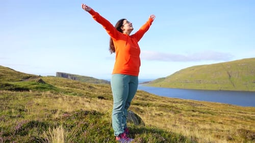 Adult woman does breathing and relaxation exercises in green environment
