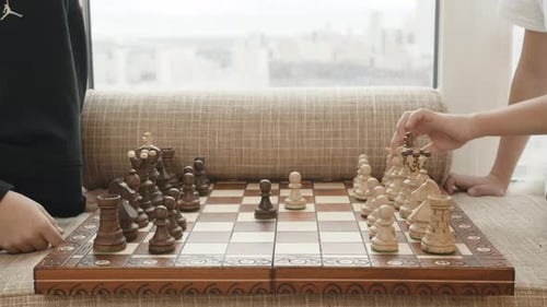 Children Playing Chess Game Indoors by Window