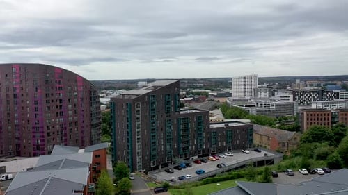 Aerial footage over looking the Leeds Town centre with grey clouds in the sky