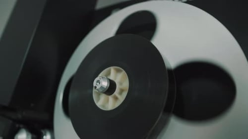 Rotating roller with 16 mm film. Digitization of film tape.