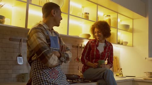 Couple Chatting Together in Warm Kitchen