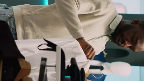 Vertical Video Store Manager Helping Client to Choose Clothes