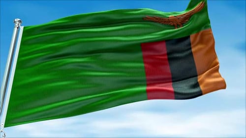 Waving Zambia Flag on Pole Against Blue Sky