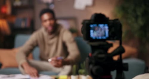 Young Adult Filming Video in Home Studio