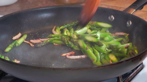 Bright Green Asparagus Cooking in a Pan