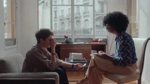 Adult Discussing Sadness With a Counselor in an Office