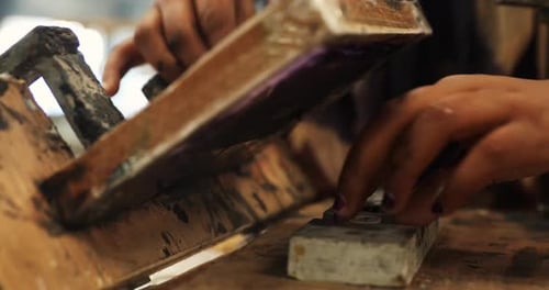 Close up of a operator doing screen printing on a plastic product - 4k