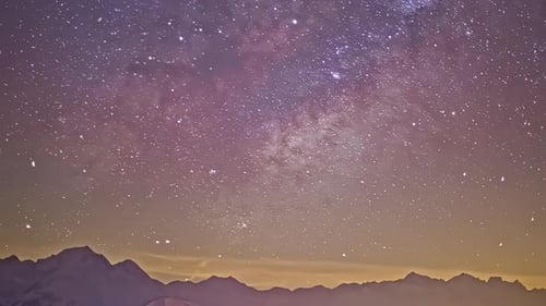 Time lapse shot of moving stars at night sky with flying meteors above mountain range silhouette - w