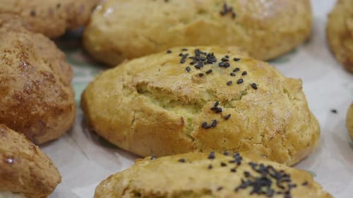 Fresh baked buns topped with black sesame seeds