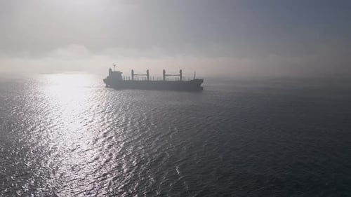 Cargo Ship Sailing Calm Ocean on a Sunny Day