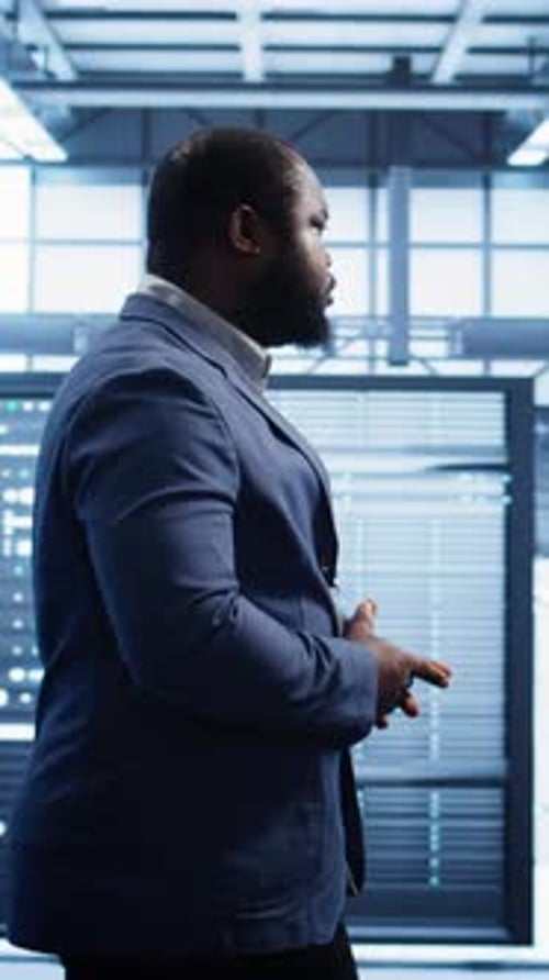 Vertical Video IT Specialist Doing Evaluation of Data Center Workspace