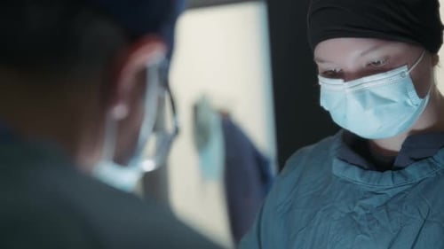 Two surgeons performing a procedure in the operating room