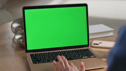 Typing on Laptop with Green Screen in Home