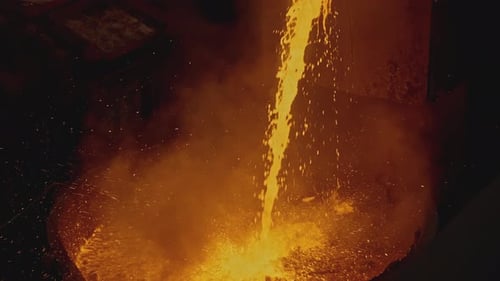 Pouring Molten Metal in Dark Industrial Factory