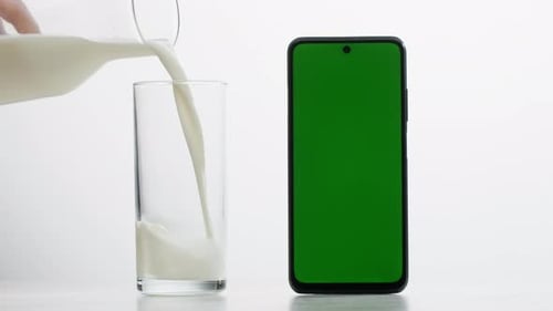 Pineapple Lemonade and Smartphone with Blue Chroma Key Screen on Orange Background Fruit Ananas