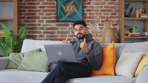 Man on Sofa Talking During Video Call