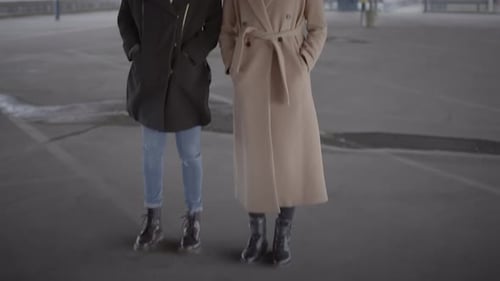 Lifestyle Portrait of Two Young Women Watching Tower Building Together