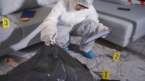 Crime Scene Investigator Taking Notes Indoors