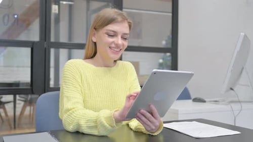 Woman Using Tablet Device in Bright Office Setting
