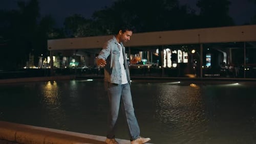 Carefree Guy Walking Night Area Near Water Pool Handsome Man Holding Glass