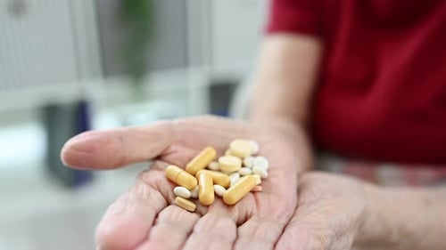 Adult Hand Holding Pills, Close Up