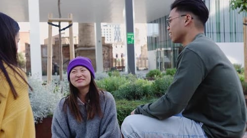 Young Trendy Asian Friends Having Fun Talking and Social Gathering at City