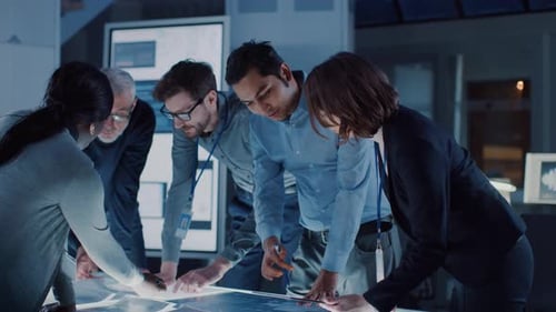 Team of Colleagues Collaborating at Illuminated Table