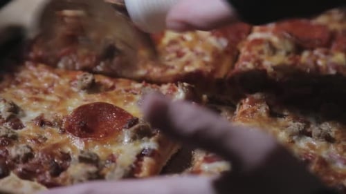 Slicing A Square Cut Pepperoni Thin Crust Pizza - Close Up Shot