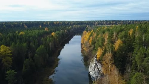 A Serene and Picturesque Autumn Landscape Featuring a Calm River Flowing Through a Lush Forest Stock