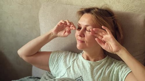 Woman Waking Up and Stretching in Bed
